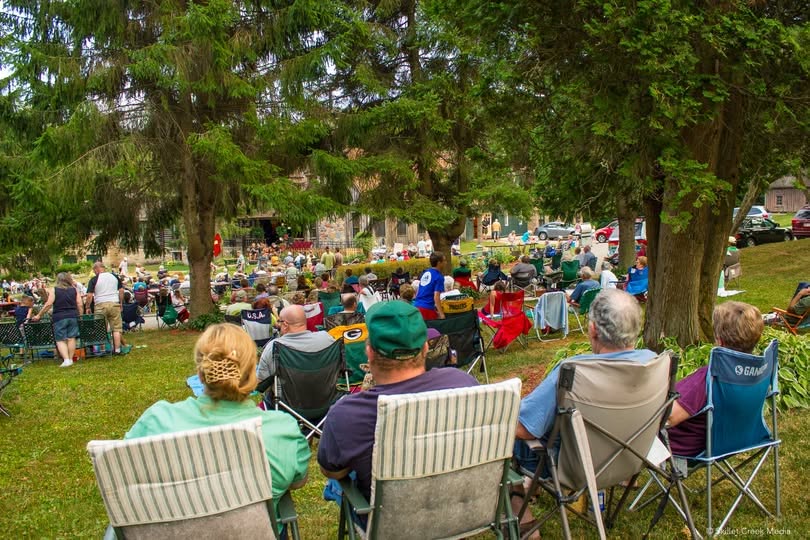 Guests seated beneath the trees for an outdoor music event at Durward's Glen